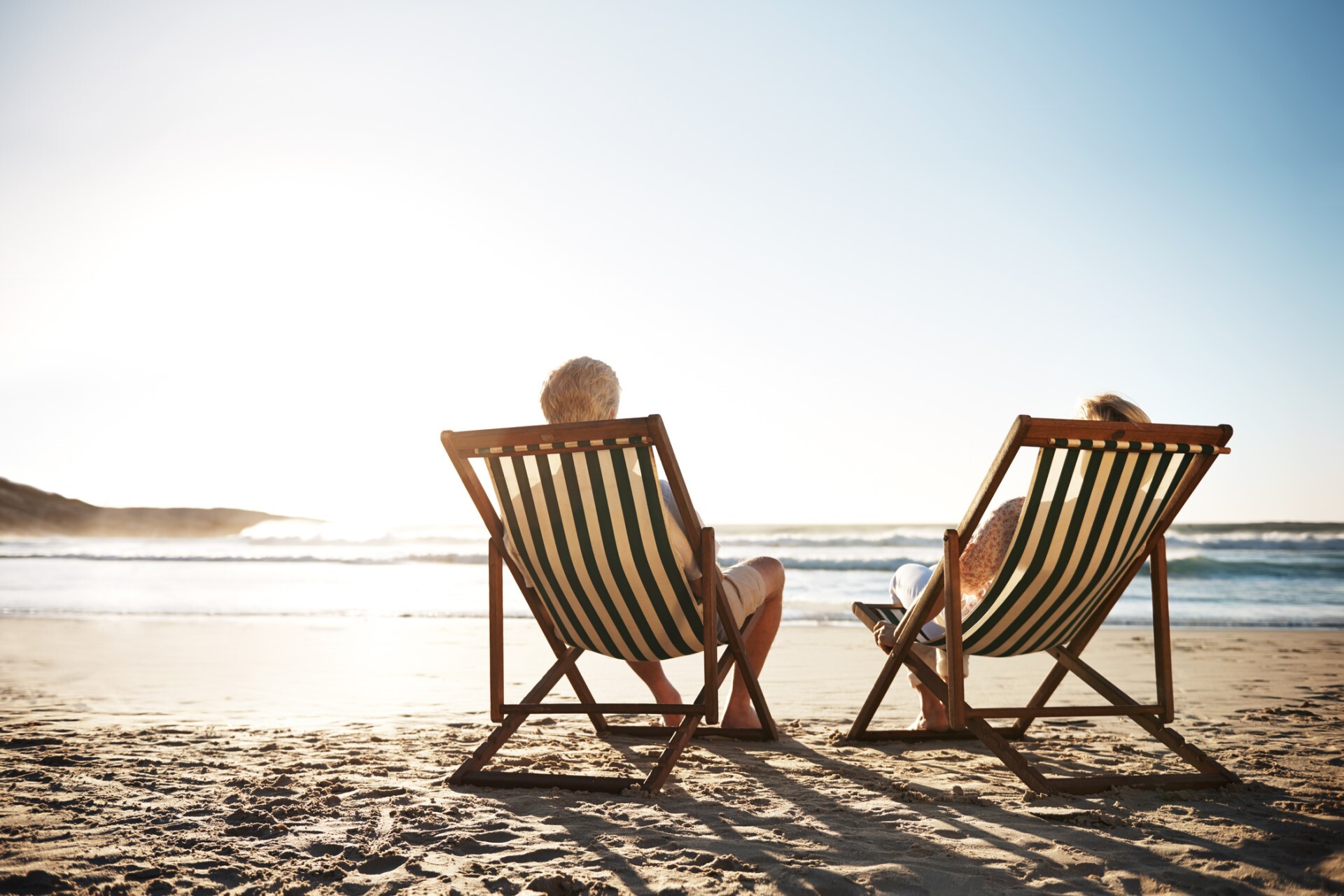 senior-couple-sitting-beach